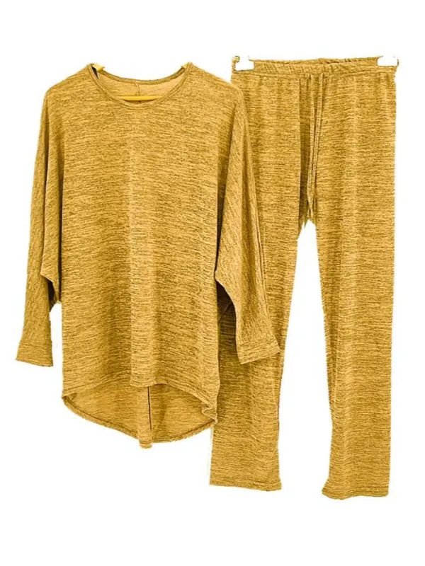 Woman wearing cozy loungewear set relaxing at home mustard